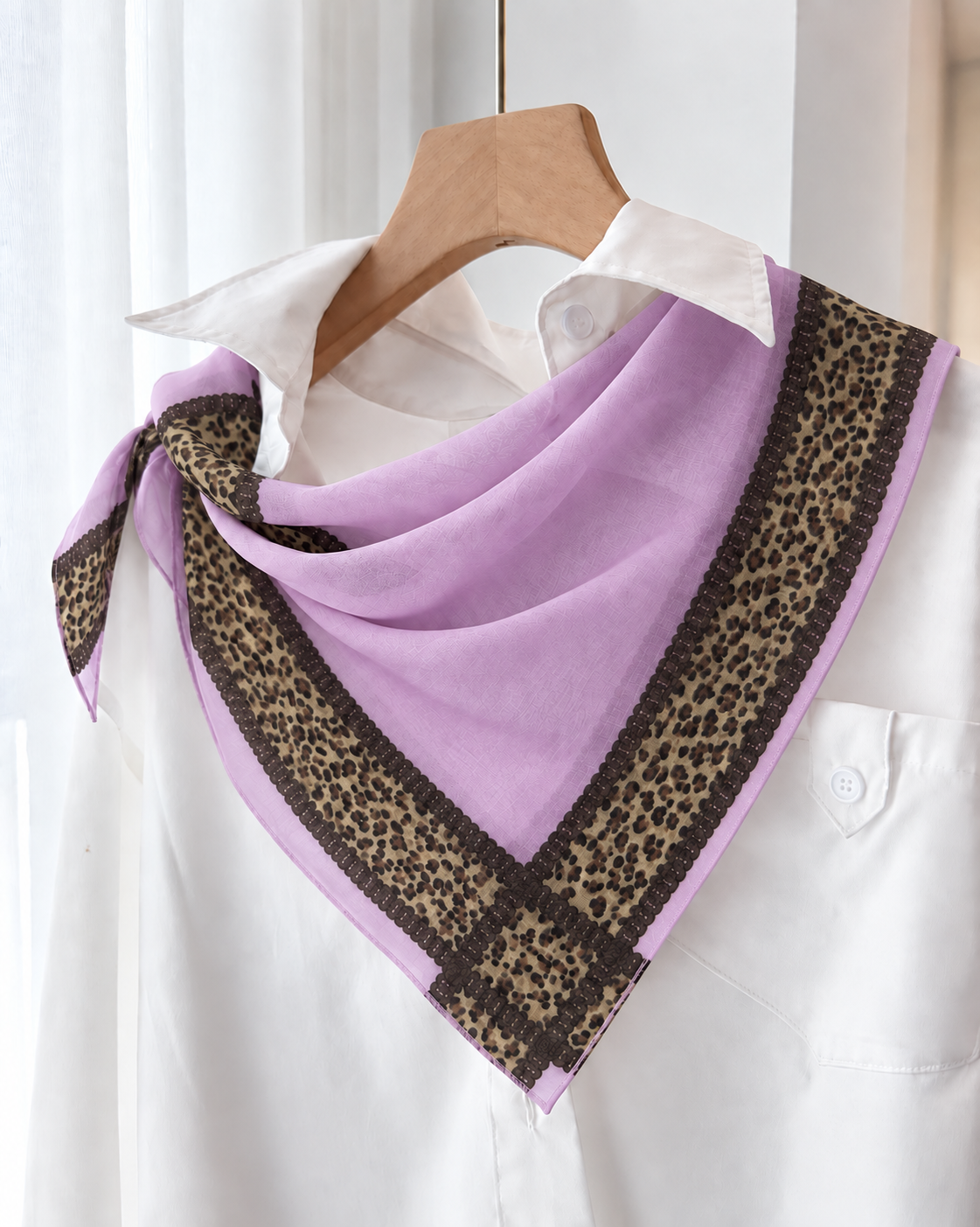 A lavender purple scarf with a brown leopard print border